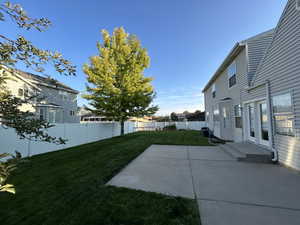 Fenced backyard with a patio