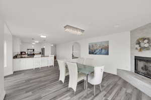 Dining room with light wood finished floors and a large fireplace