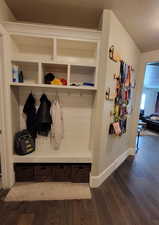 Mudroom featuring dark wood finished floors and a textured ceiling