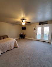 Second Master Bedroom featuring access to exterior, carpet floors, a textured ceiling, and ceiling fan and a walk-in closet