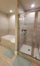 Master bathroom with a shower stall, a garden tub, recessed lighting, and wood finished floors