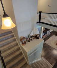Stairway featuring wood finished floors and baseboards