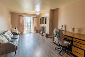 Living room with sliding glass doors and balcony that face the South and East Mountains