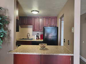 Kitchen with tile flooring, gas range and dishwasher