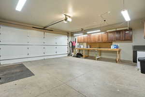 Garage with a central vacuum unit and a garage door opener