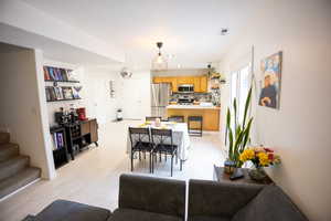 Living area with stairs, light wood-style floors, and recessed lighting