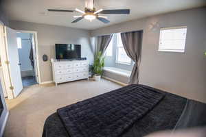 Bedroom featuring light colored carpet and a ceiling fan