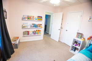 Playroom featuring light colored carpet and baseboards
