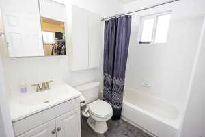 Full Master bathroom featuring vanity, shower / bathtub combination with curtain, and dark wood finished floors