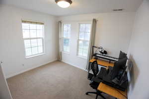 Office space featuring light colored carpet and baseboards