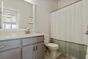 Bathroom featuring vanity, light tile patterned floors, and a shower with curtain