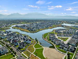 Aerial view of property's location featuring nearby suburban area and a water and mountain view