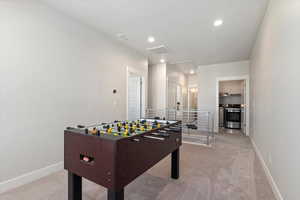 Rec room with light carpet, recessed lighting, separate washer and dryer, and a textured ceiling