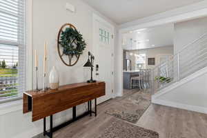Foyer with light wood-style flooring and stairway