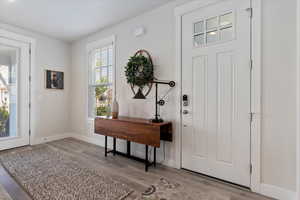 Foyer entrance with baseboards and light wood-style floors