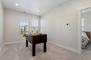 Recreation room featuring light carpet and recessed lighting