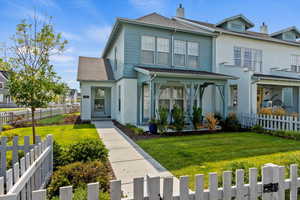 Traditional-style home featuring roof with shingles and stucco siding