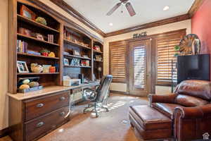 Home office featuring crown molding, light colored carpet, a ceiling fan, built in desk, and recessed lighting