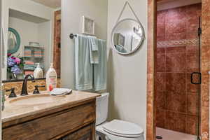 Bathroom featuring a stall shower and vanity