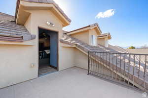 Property entrance with stucco siding and a tiled roof