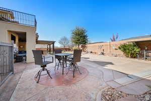 Fenced backyard with a patio and outdoor dining area