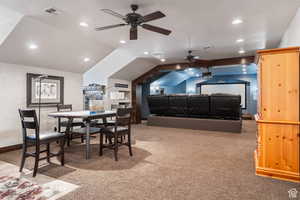 Dining area with vaulted ceiling, light colored carpet, recessed lighting, a textured ceiling, and a ceiling fan