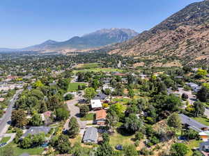 Aerial view of property's location with nearby suburban area and a mountainous background