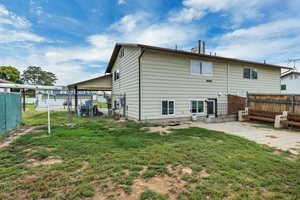 Rear view of house with a patio and a gate