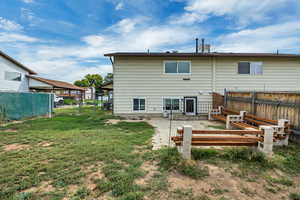 Rear view of house featuring a patio and a fenced backyard