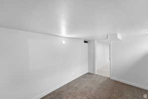 Finished below grade area featuring carpet floors and baseboards