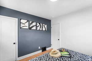 Bedroom featuring light wood-style floors and baseboards