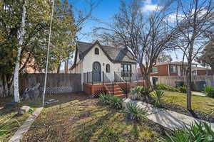 View of front of property with a deck and brick siding