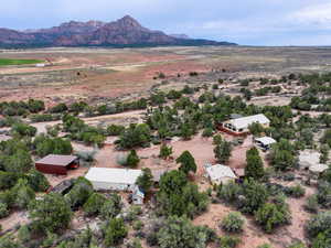 Aerial view of sparsely populated area with a desert landscape and a mountainous background