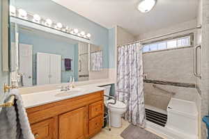 Full bathroom featuring vanity and a shower stall