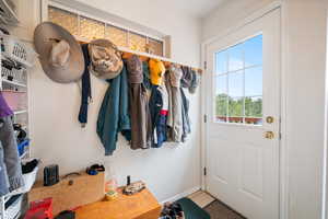 Mudroom with tile patterned flooring