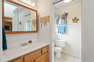 Bathroom featuring light tile patterned flooring and vanity
