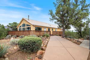 View of front of property featuring a tile roof and stucco siding