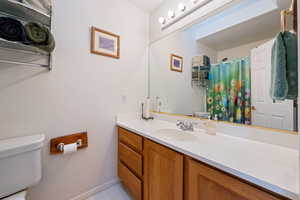 Full bath featuring vanity, a shower with curtain, and light tile patterned flooring