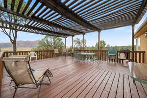 Wooden terrace with a mountain view and outdoor dining area