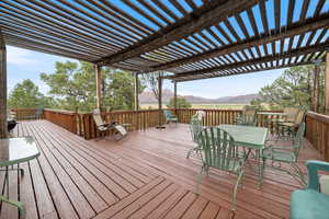Deck with a mountain view and outdoor dining space
