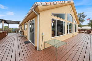 Wooden deck featuring area for grilling