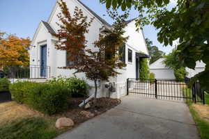 View of property exterior with brick siding and a gate