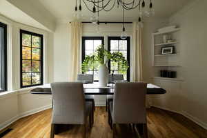 Dining space featuring ornamental molding and wood finished floors