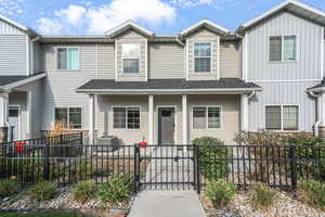 View of front of house with a gate, a fenced front yard, covered porch, and board and batten siding