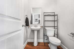 Bathroom featuring dark wood finished floors and toilet