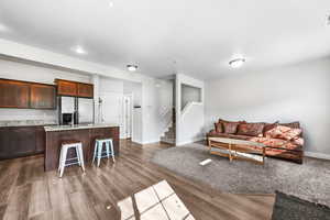 Living room featuring stairs and dark wood-type flooring