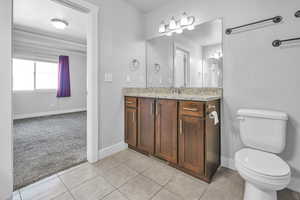 Bathroom featuring vanity, light tile patterned flooring, and a textured ceiling