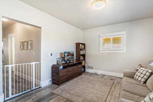 Living room featuring ornamental molding and wood finished floors