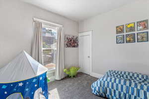 Carpeted bedroom featuring baseboards
