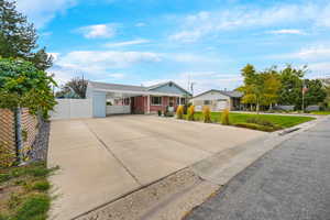 Single story home featuring concrete driveway, a carport, and brick siding